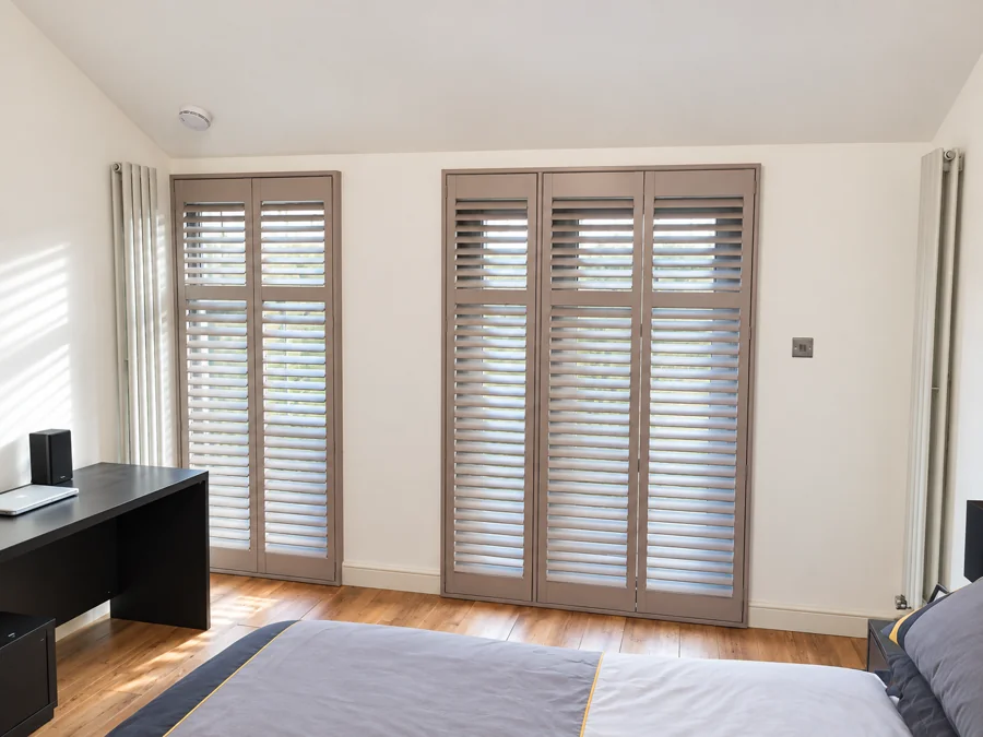 Grey shutters across tall glazed doors