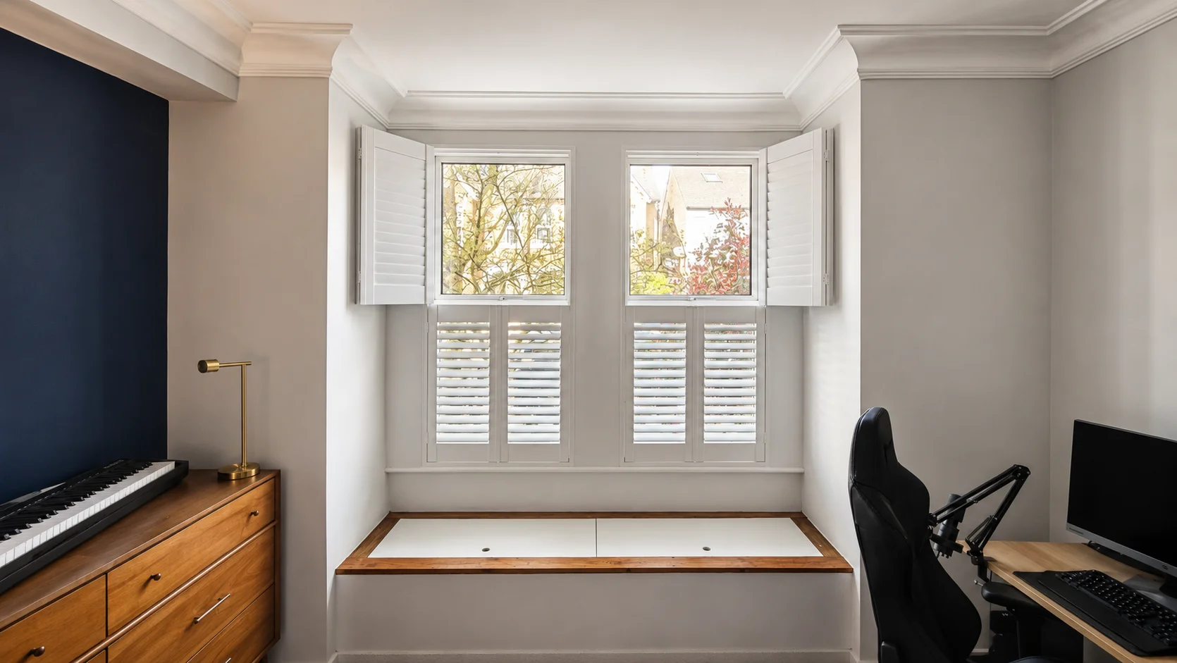 White tier-on-tier shutters beside a bedroom radiator