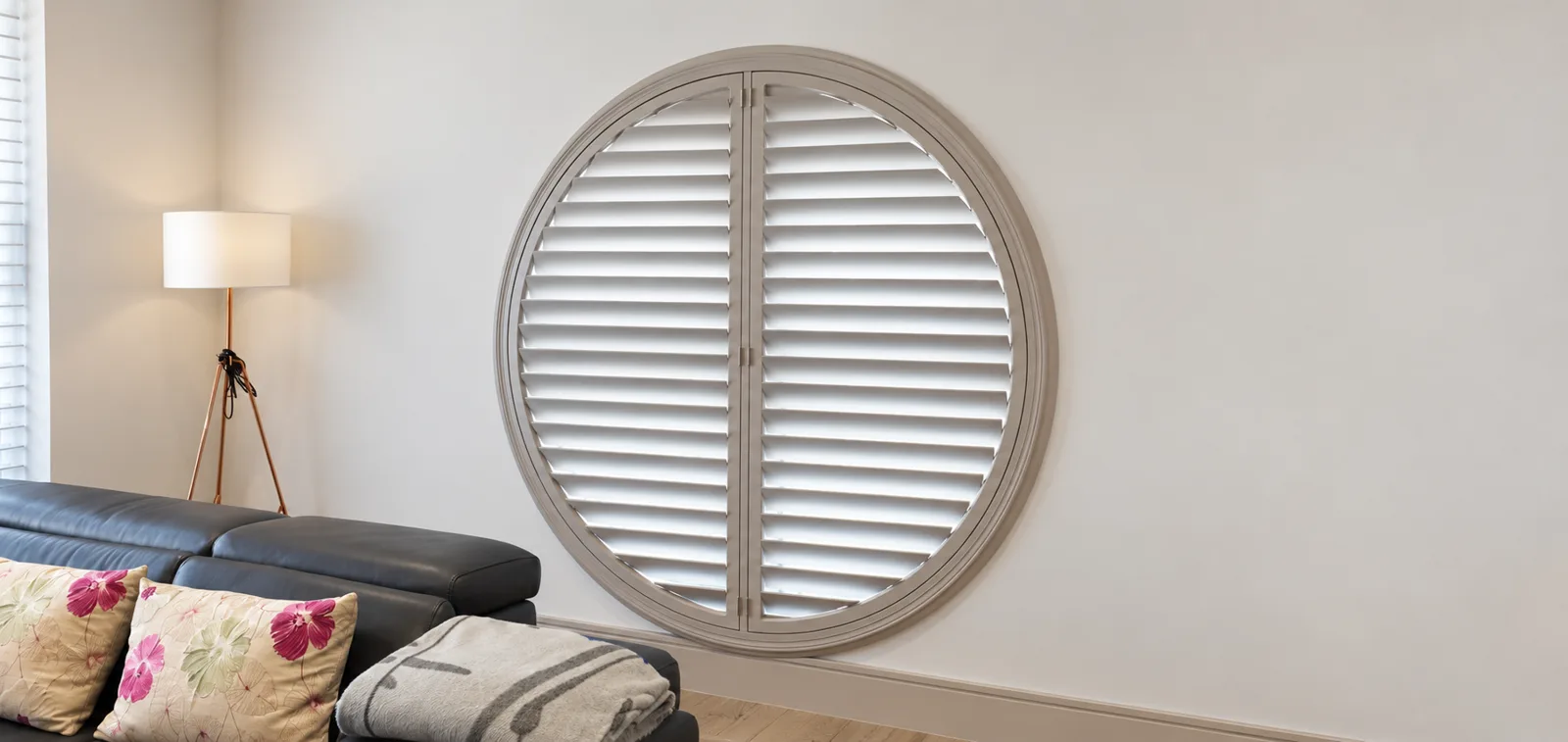 Circular white shutter fitted to a round window