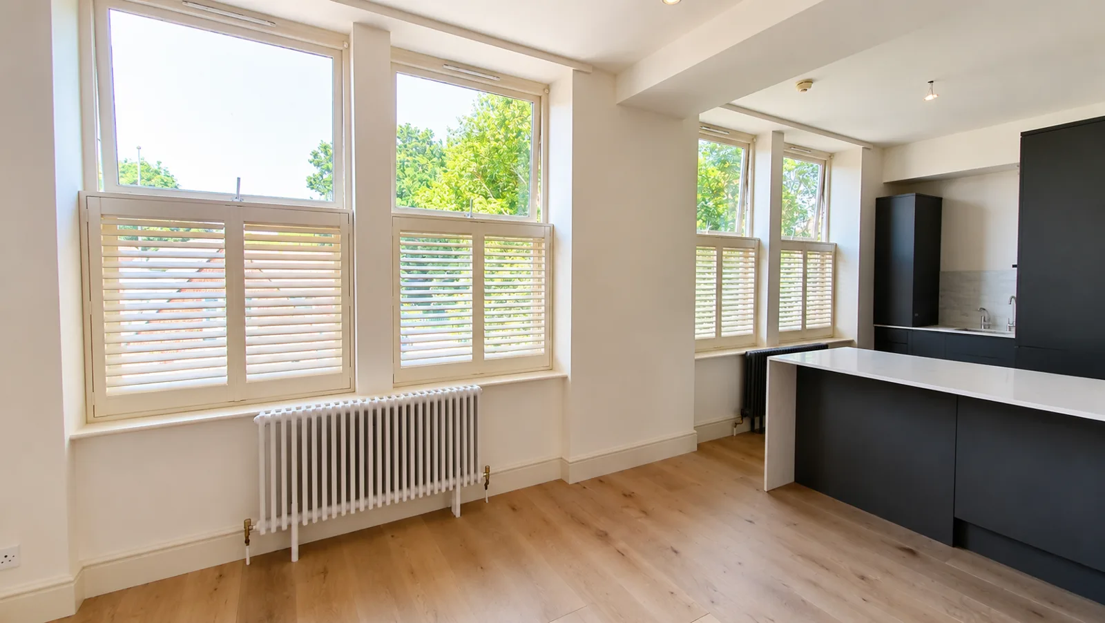 White café-style shutters across kitchen windows