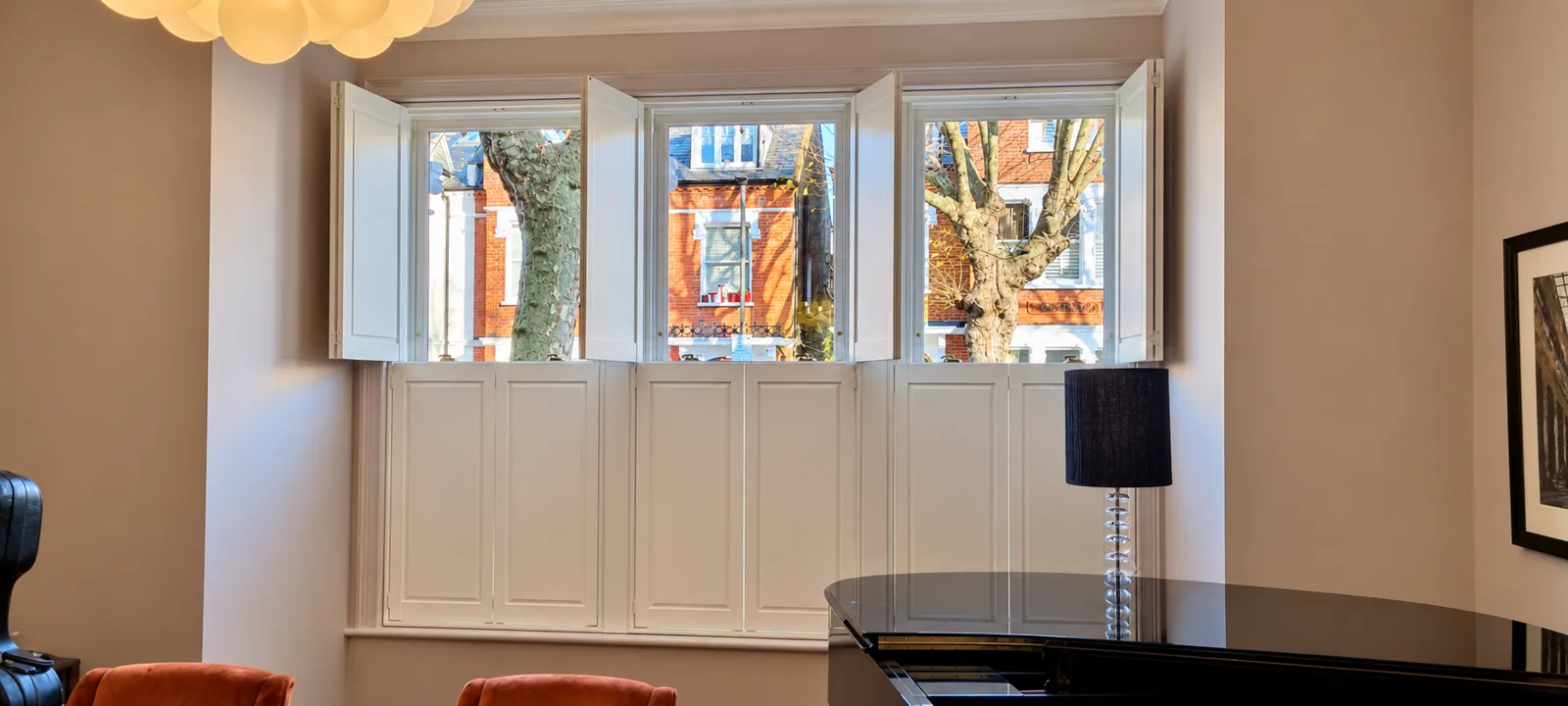 White solid-panel shutters with their upper sections open