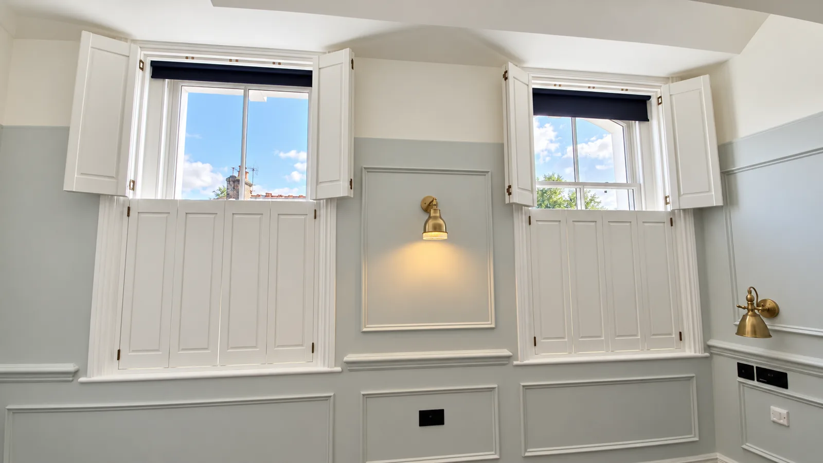 White solid-panel shutters beside a kitchen worktop