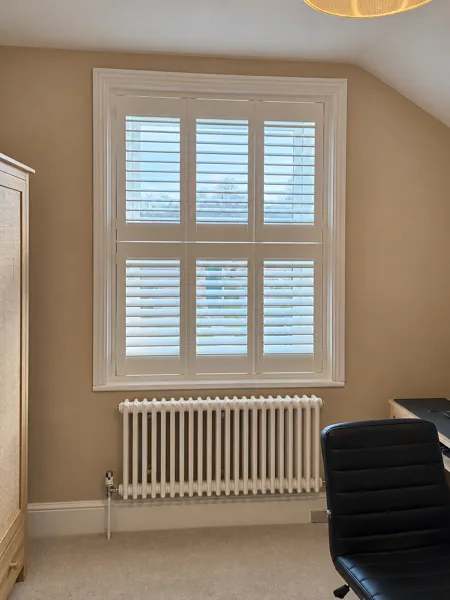 Pure White tier-on-tier shutters closed across a Basingstoke office window
