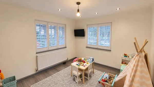 Hardwood shutters across two windows in a High Wycombe playroom
