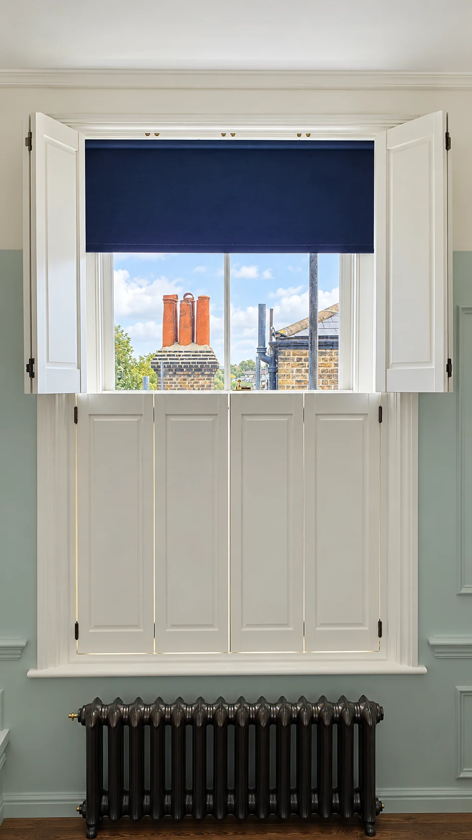 White solid-panel shutters with upper panels open above a radiator